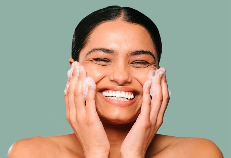 Woman using DermaVeen Foaming Facial Cleanser