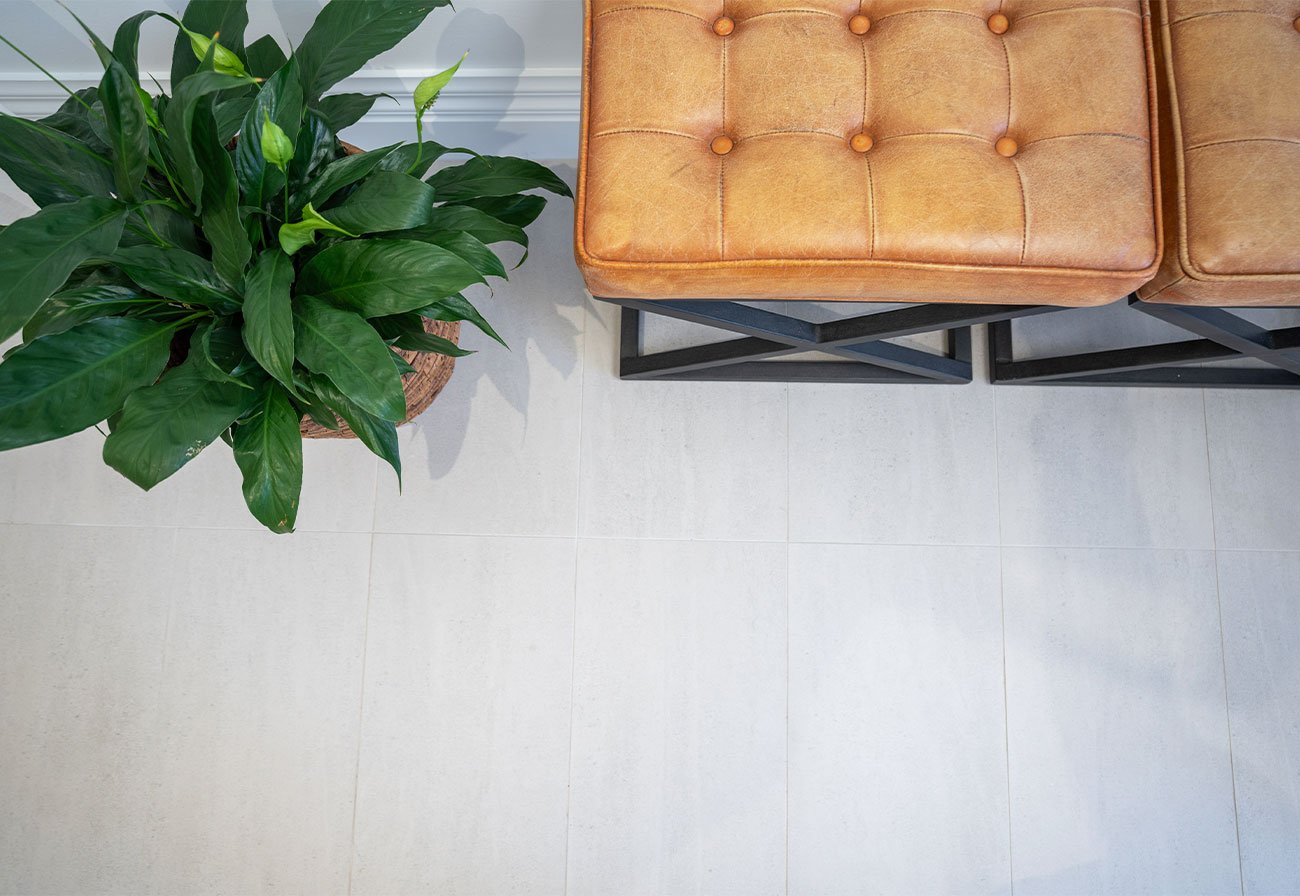 White Riverstone interior tiles under a tan leather seat.