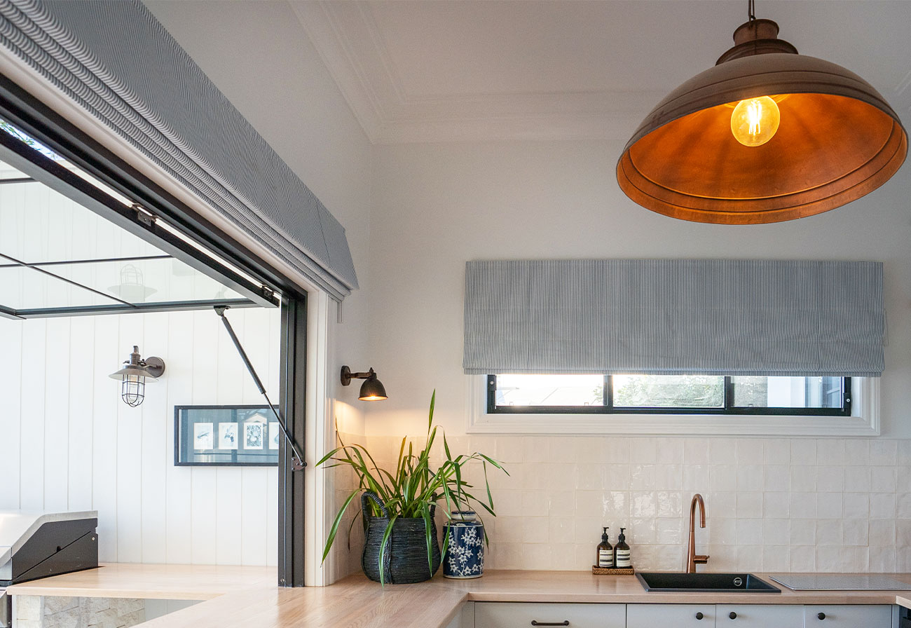 Modern Farmhouse laundry with blue roman blinds on windows.