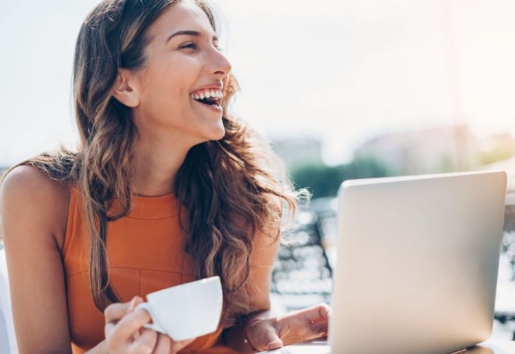 Laughing woman on a computer.