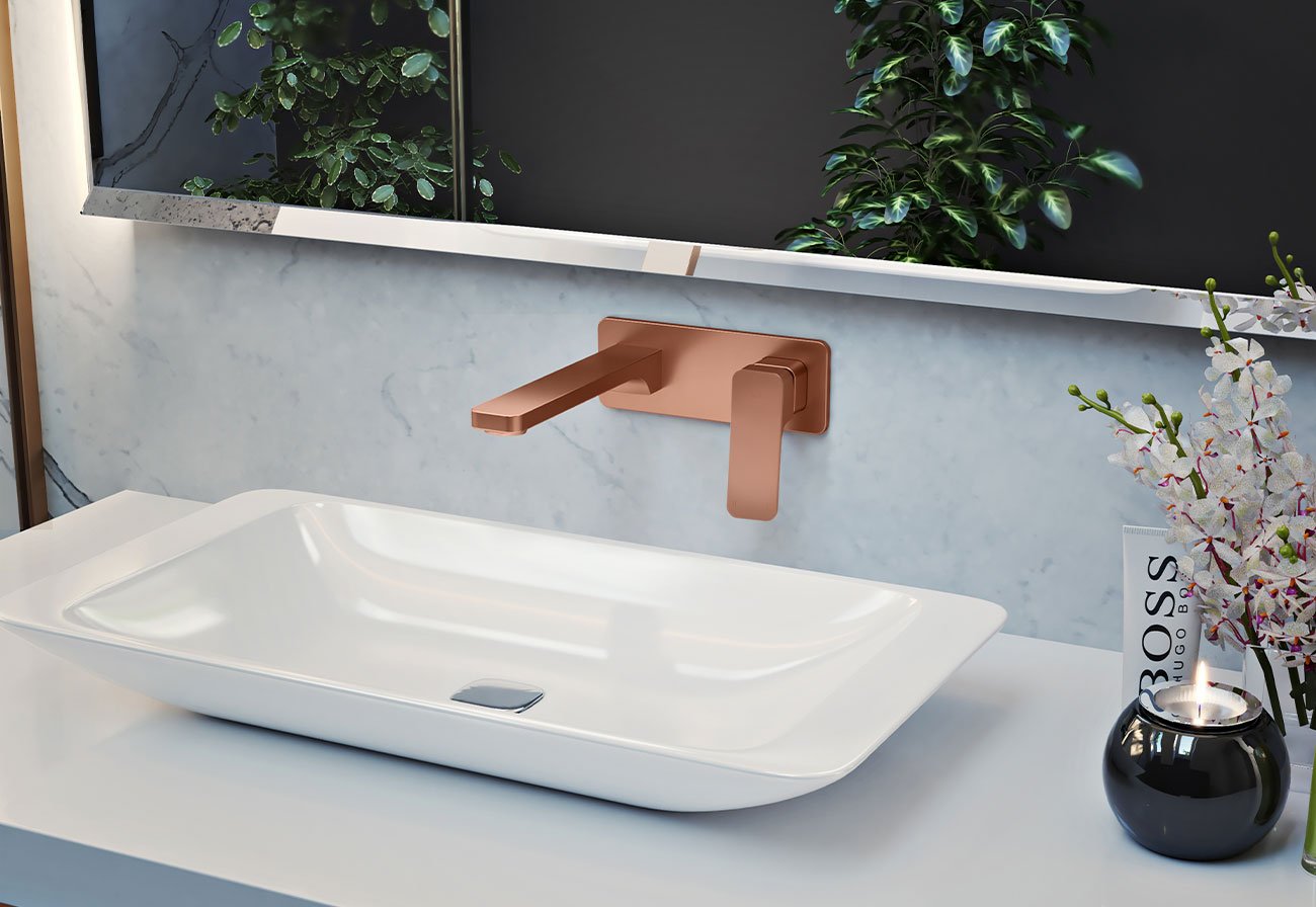 Brushed copper wall tap with a white rectangular basin.