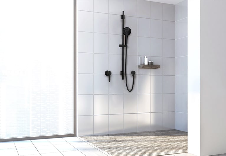 Matte black rail shower in a while tiled shower cubicle.