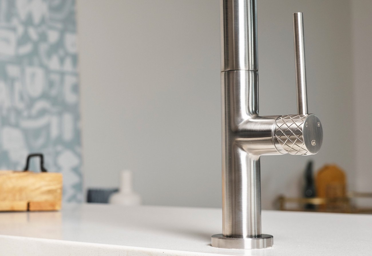 Brushed stainless kitchen sink handle with trending textured elements.