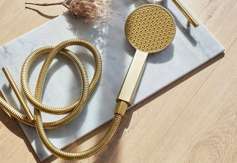 Brushed brass shower head.