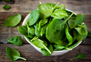baby spinach spilling over bowl