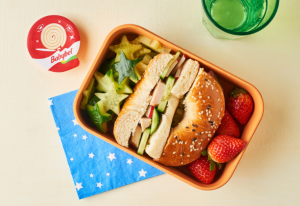 Babybel Mini Roll next to an open lunchbox.