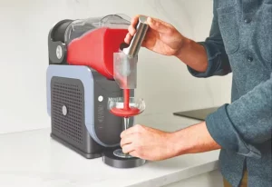 Person using the Ninja Slushie Maker.