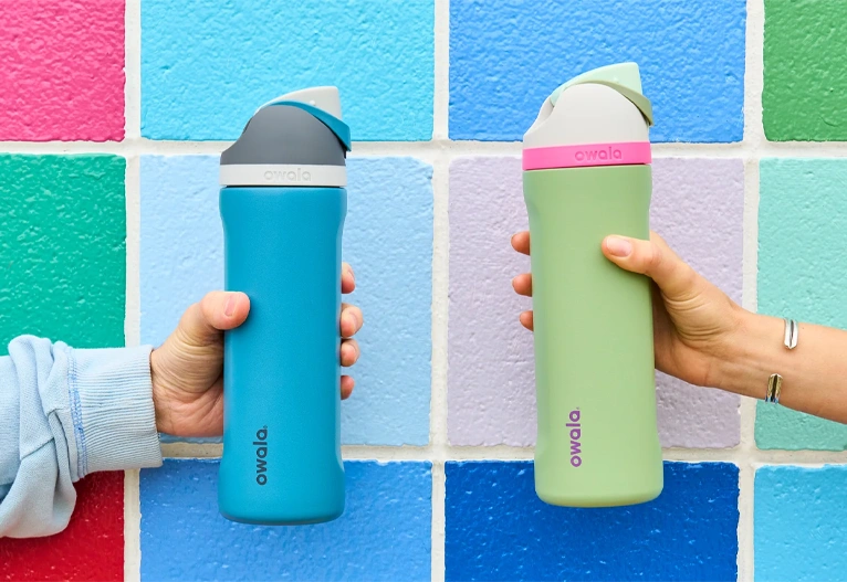 Owala FreeSip drink bottles in blue and green.