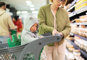 Woman and baby grocery shopping.